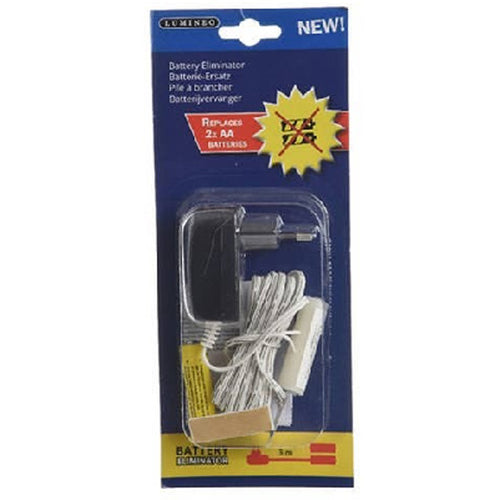 Battery eliminator accessory photographed in dark blue blister packaging, showing a black adaptor with two round pins, a coiled pale lead and pale battery-shaped pieces; the red panel reads Replaces 2x AA batteries and the yellow bottom diagram is labelled 3m.