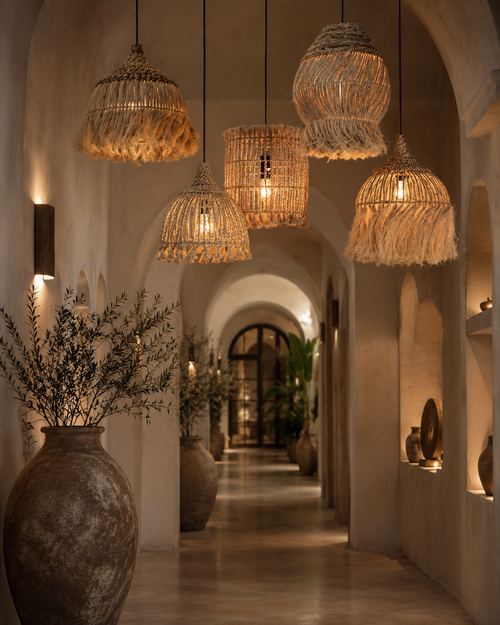 Abaca Hoola Pendant Light – Natural, Large – multiple lights suspended in an arched hallway