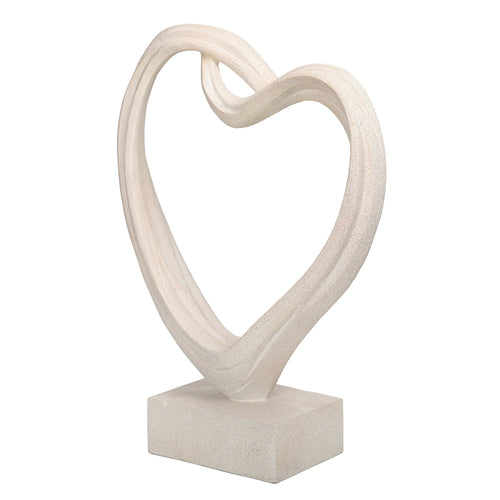 Angled view of the white heart sculpture showing the depth of its curved form and rectangular plinth.