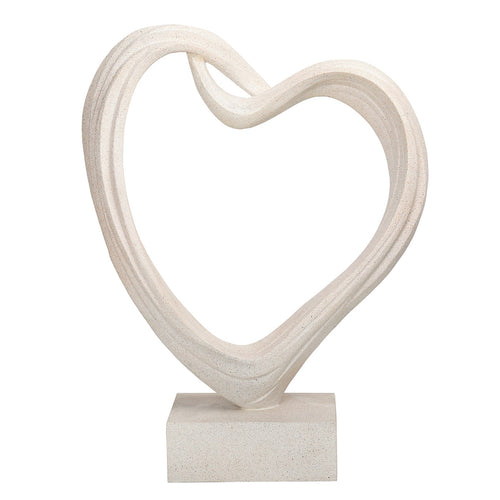 White open-heart sculpture on a rectangular plinth, showing grooved curves and an overlapping loop at the top.