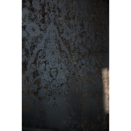 Close-up of the Agepattern Wall Mirror surface, showing irregular brown and silver flecks across a dark grey reflective background.