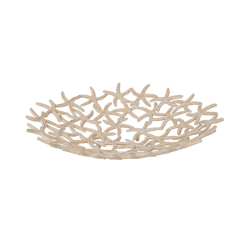 Angled view of the pale beige Alluvium Bowl, showing its shallow shape and overlapping starfish lattice.