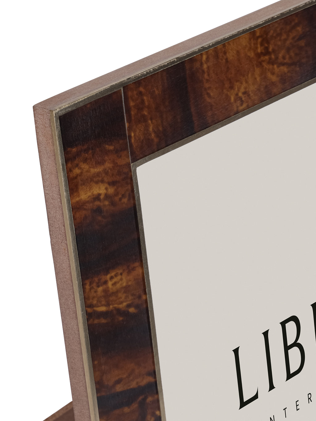 Close-up of the frame's upper left corner, with mottled amber and dark brown bands bordered by narrow brass strips.