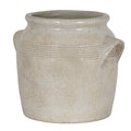 Cream planter viewed at an angle, showing its open flared rim, banded shoulders and projecting right-hand handle.