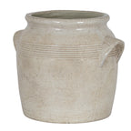 Cream planter viewed at an angle, showing its open flared rim, banded shoulders and projecting right-hand handle.