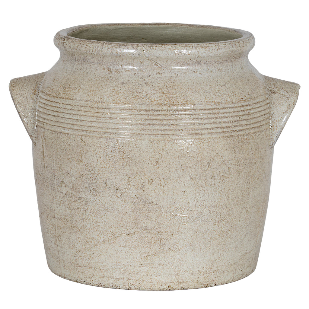 Front view of the pale cream planter with angular handles on both sides and warm-beige mottling across its rounded body.