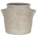 Front view of the pale cream planter with angular handles on both sides and warm-beige mottling across its rounded body.