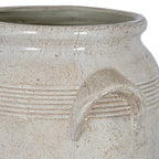 Close view of the planter's rim and one angular handle, showing fine horizontal bands, beige speckles and a softly reflective surface.