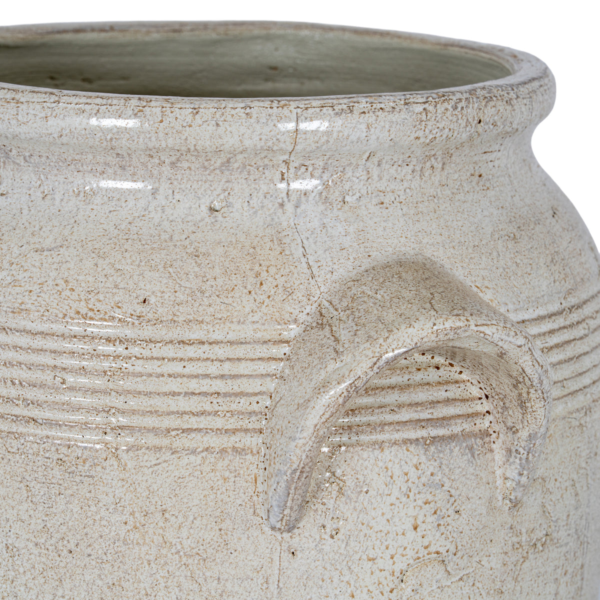 Close view of the planter's rim and one angular handle, showing fine horizontal bands, beige speckles and a softly reflective surface.