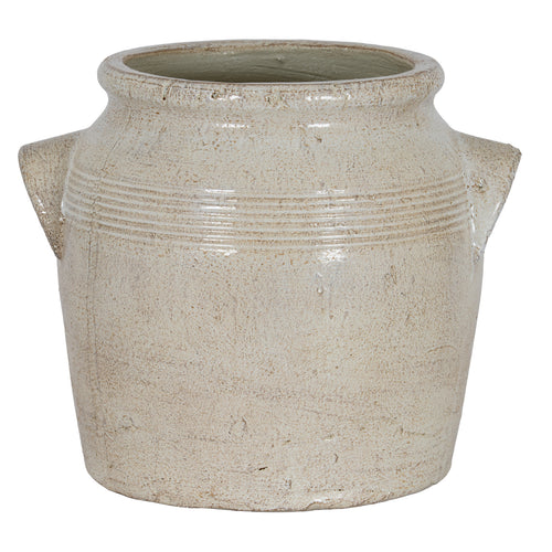 Front view of the rounded cream planter with handles extending to either side and warm-beige mottling across the body.