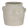 Pale cream planter viewed at a slight angle, showing its broad open mouth, banded shoulder and angular side handles.
