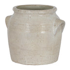 Pale cream planter viewed at a slight angle, showing its broad open mouth, banded shoulder and angular side handles.