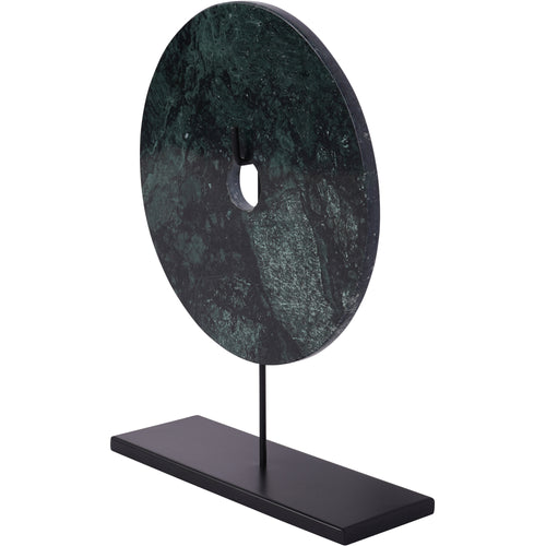 Angled view of the marble disc showing its thickness, patterned green face and elongated black plinth.