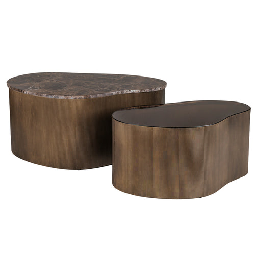 Two asymmetrical coffee tables arranged offset, with a larger brown marble top and smaller brown glass top on ribbed gold bases.