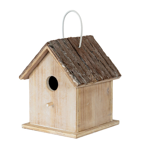 Three-quarter front view of a pale wooden birdhouse with a circular entrance, short dowel, dark pitched roof, pale loop and square base.