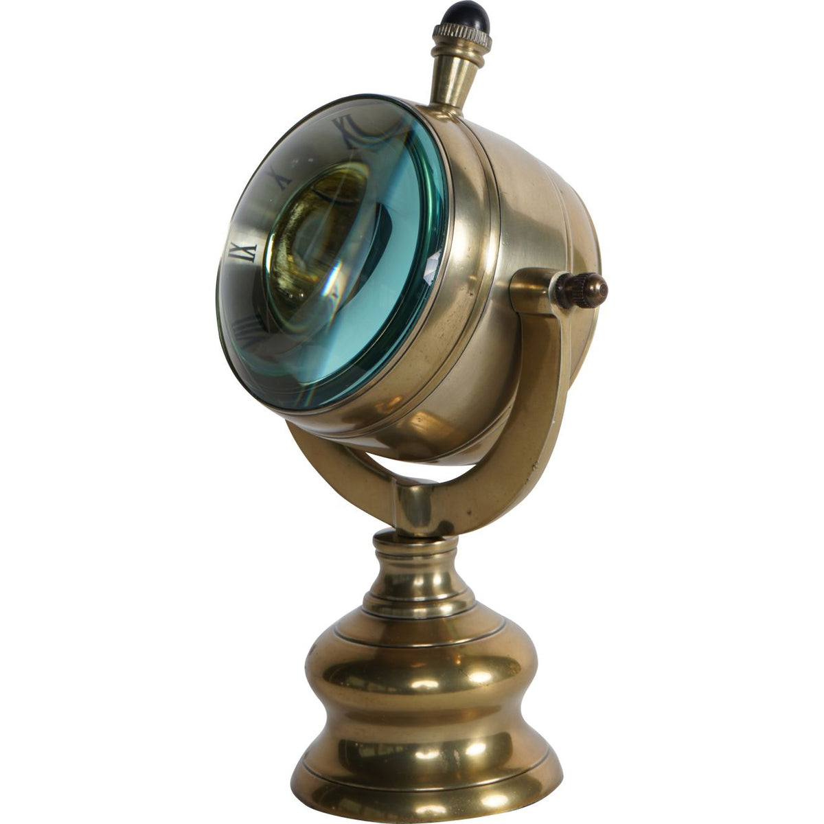 Angled view showing the clock's deep drum case, outward-curving transparent front and dark-capped crown.