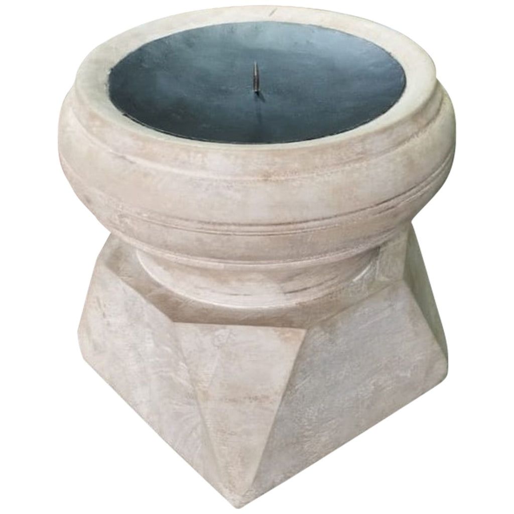 Angled view of a pale wooden candle holder with a faceted base, rounded top and dark inset candle plate with a central spike.