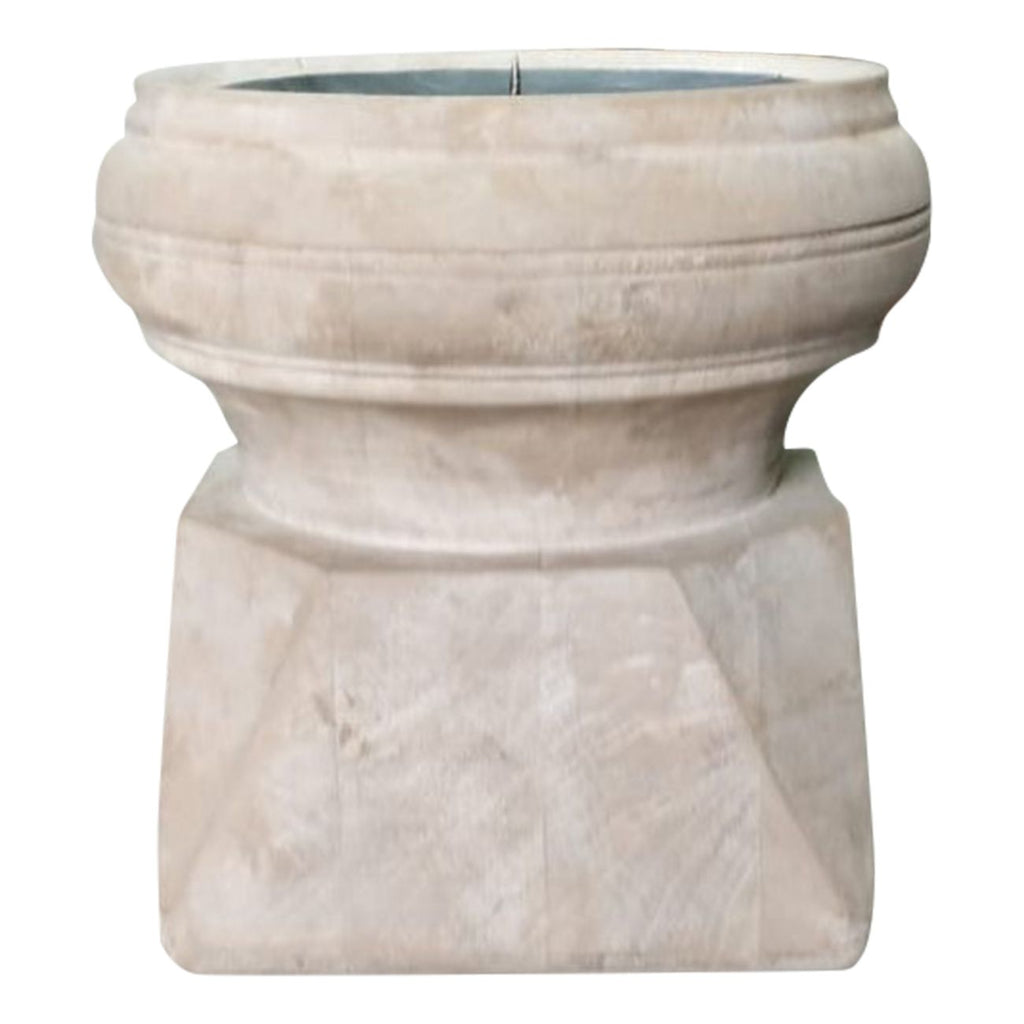 Front view of the pale wooden candle holder showing its broad rounded rim, narrow middle and angular base with visible wood grain.