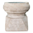 Front view of the pale wooden candle holder showing its broad rounded rim, narrow middle and angular base with visible wood grain.