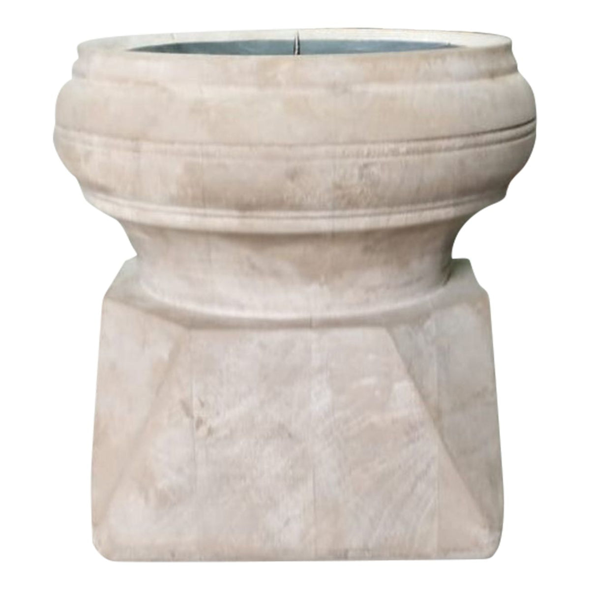 Front view of the pale wooden candle holder showing its broad rounded rim, narrow middle and angular base with visible wood grain.