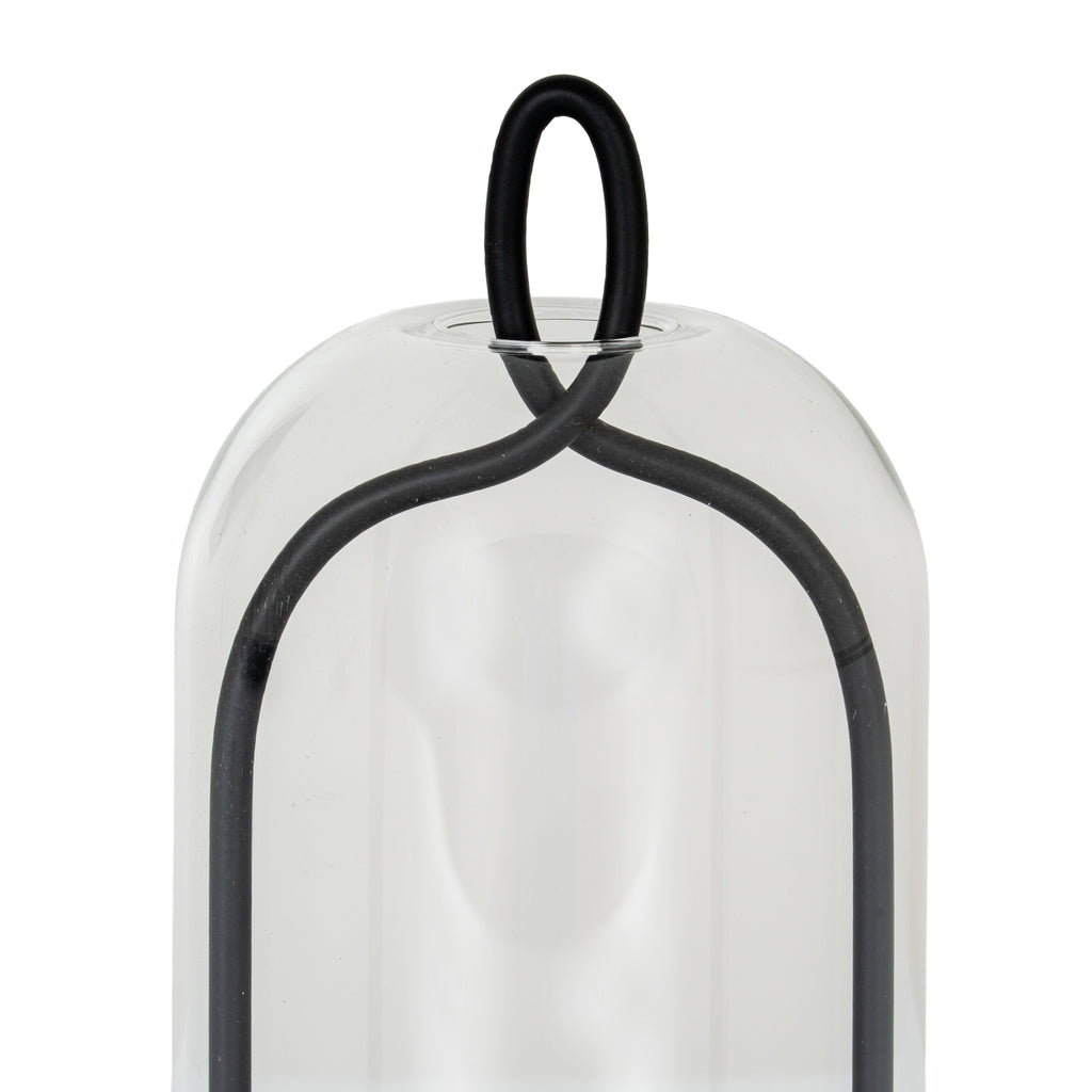 Close-up of the black oval loop and crossing curved frame at the rounded top of the clear cloche.