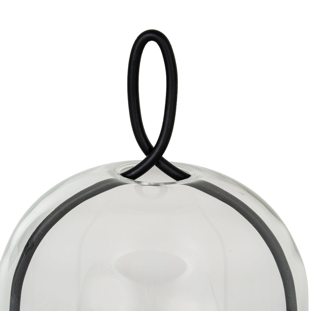 Close-up of the black oval loop crossing at the top of the clear cloche, with the curved side frame visible below.