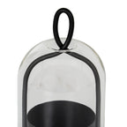 Close-up of the oval black loop above the rounded clear cloche, with the curved side frame and open candle cup visible below.