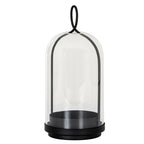 Full view of the black Archloop candle holder with a stepped round base, deep candle cup and arched frame beneath a clear bell-shaped cloche.
