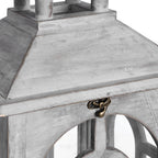 Close-up of the lantern roof and front clasp, showing rubbed pale grey colouring and the top of an arched frame.