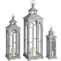 Three pale grey Archwindow lanterns in graduated sizes, with pitched roofs, loop tops and cream pillar candles shown inside.