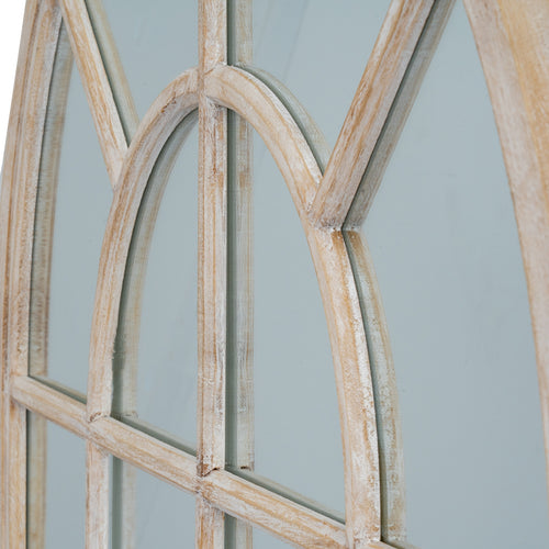 Angled close-up of the mirror's inner arch and radiating bars, showing pale streaks over warm beige tones and their reflected edges.
