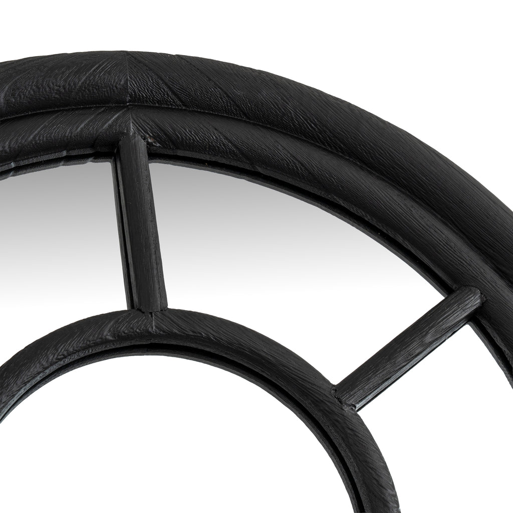 Close-up of the curved outer frame above the smaller inner arch, with a central vertical bar and a diagonal bar to the right.