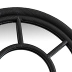 Close-up of the curved outer frame above the smaller inner arch, with a central vertical bar and a diagonal bar to the right.