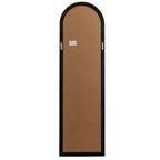 Rear view of the arched mirror showing a brown backing panel, black border, two hanging loops and a small warning label.