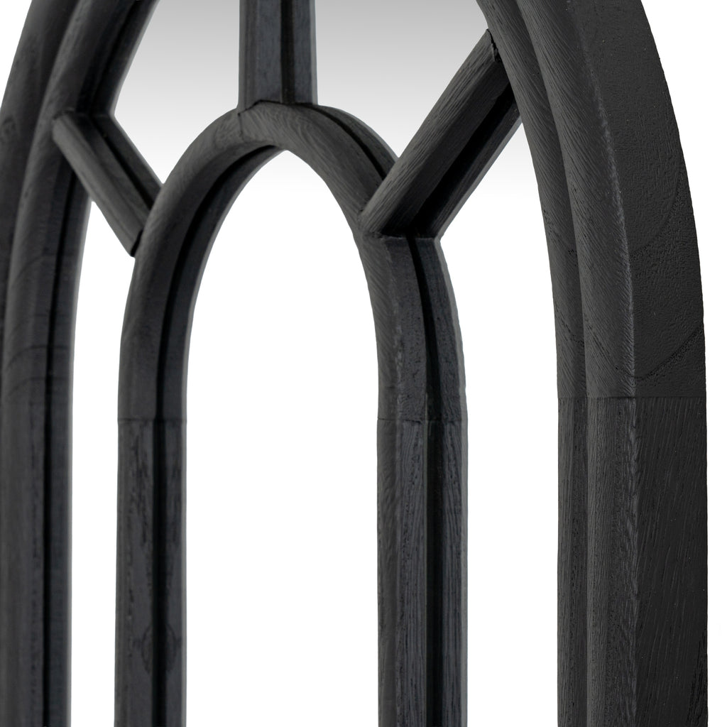 Angled close-up of the mirror's inner arch and diagonal bars, showing grain-like texture on the black surfaces.