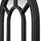 Angled close-up of the mirror's inner arch and diagonal bars, showing grain-like texture on the black surfaces.
