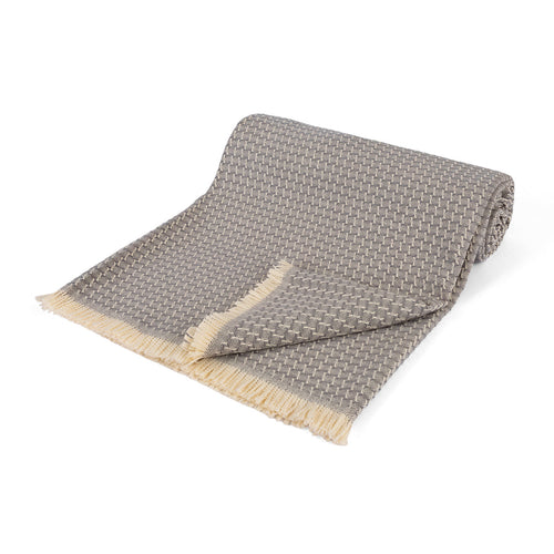 Aris Weave Throw draped open to show its grey woven pattern and cream fringe