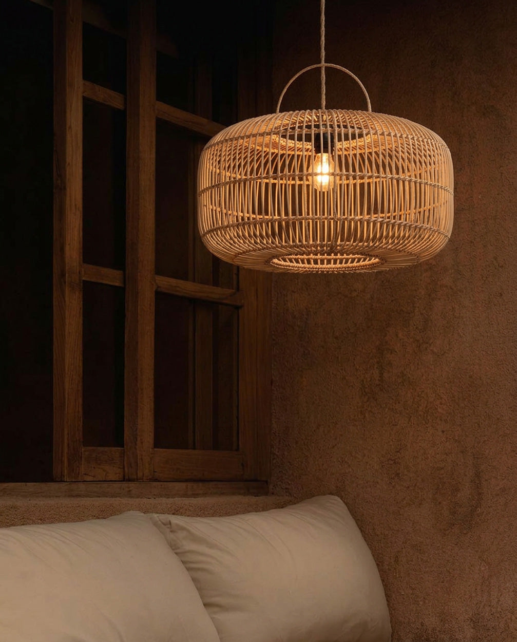 Arun Rattan Pendant Light – Natural, Large – illuminated above a sofa in a warm interior