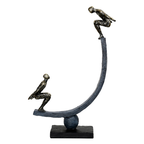 Ascension Sculpture with the upper figure on the right and lower figure on the left, on a dark curved arc above a sphere and plinth.
