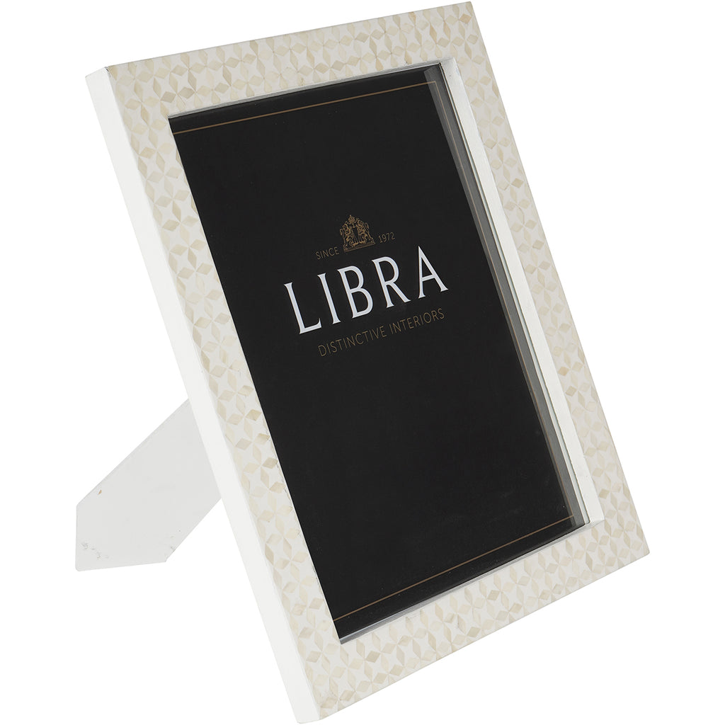 Angled front view of a white photo frame with pale geometric bone inlay, a black display insert and its rear stand extended.