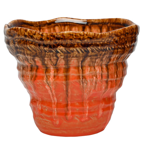 Front view of the small Aubade planter with a flared wavy rim and dark amber glaze trails over its ribbed coral-orange body.