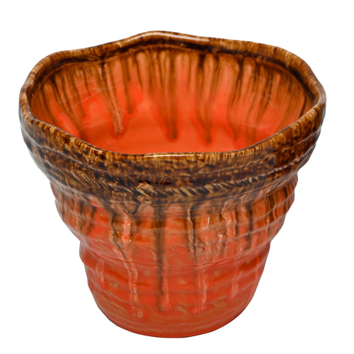 Elevated view of the planter showing its broad, softly squared opening, orange interior and mottled brown rim.