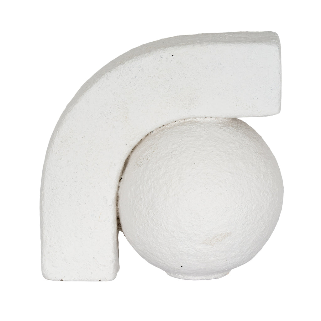 Close-up of an off-white bookend showing the arch curving over a round ball, with fine pits and uneven surface texture.