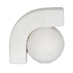 Close-up of an off-white bookend showing the arch curving over a round ball, with fine pits and uneven surface texture.