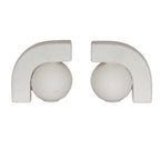Two off-white ball-and-arch bookends facing one another against a white background, with textured spheres beneath thick squared arches.