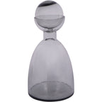 Smoky grey glass bottle vase with its ball top in place, shown upright against a white background.