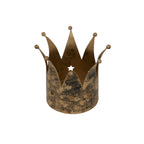 Angled view into the open gold crown candle holder, showing its interior, overlapping pointed panels and a star cut-out in the back wall.