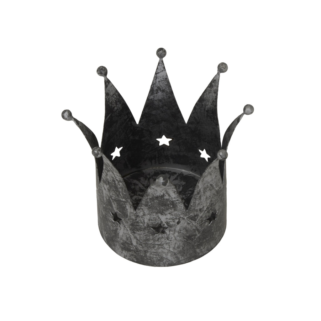 View down into the open crown candle holder, showing its circular base, overlapping pointed panels and star cut-outs through the back wall.