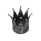 View down into the open crown candle holder, showing its circular base, overlapping pointed panels and star cut-outs through the back wall.