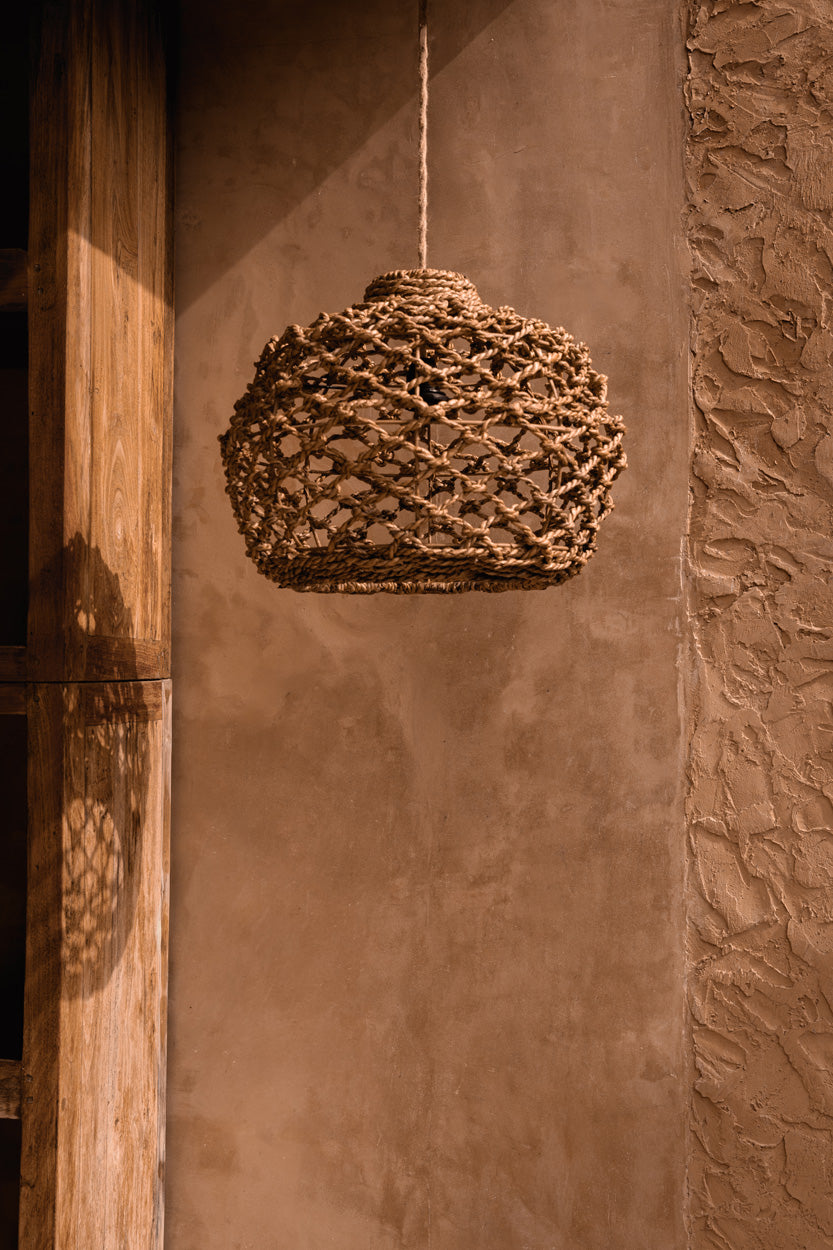 Banara Banana Leaf Pendant Light – Natural, Small — styled against a warm wall
